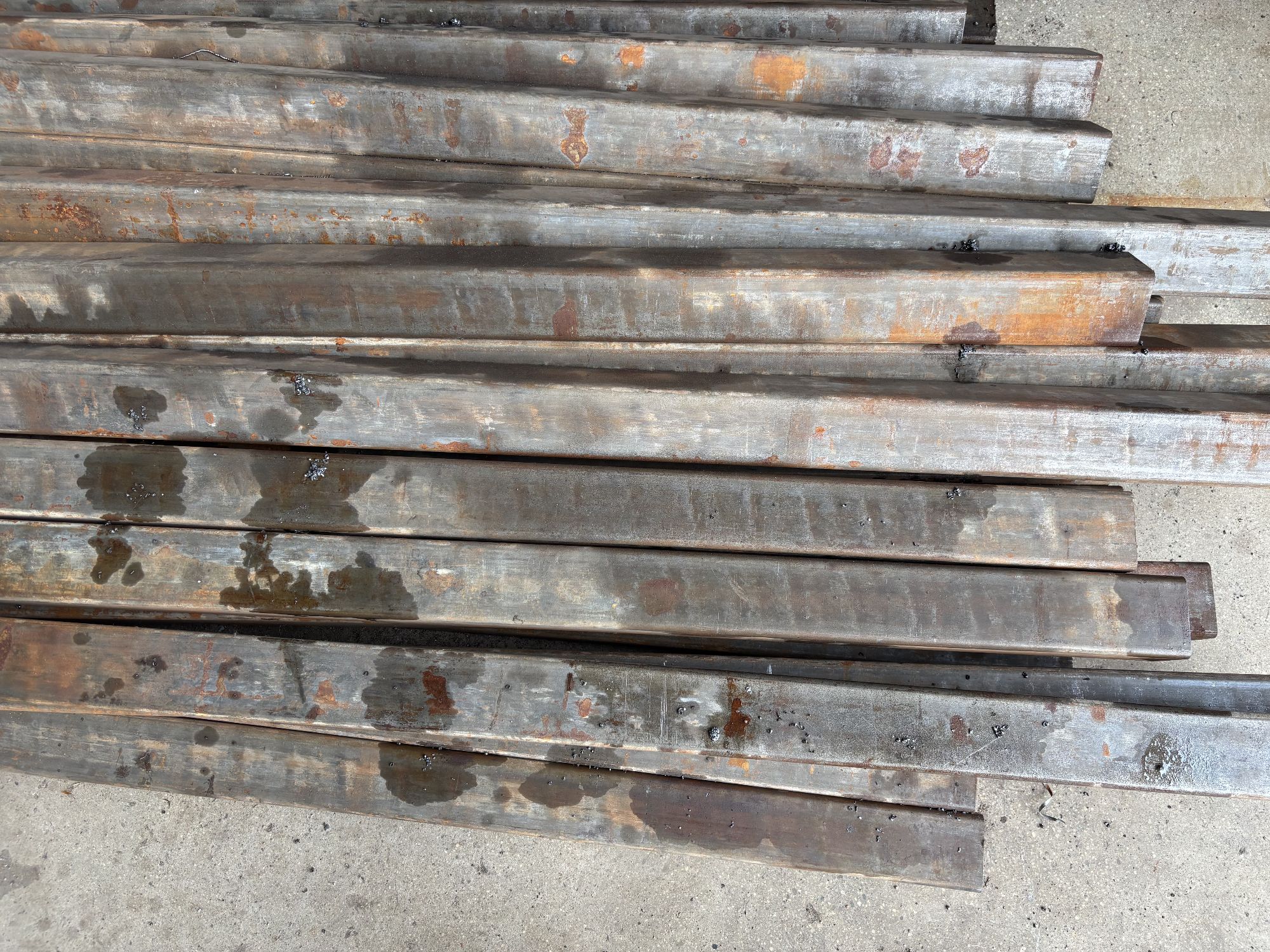 Batch of customer-submitted square tubes for straightening trial &mdash; mixed sizes and conditions tested on a single machine