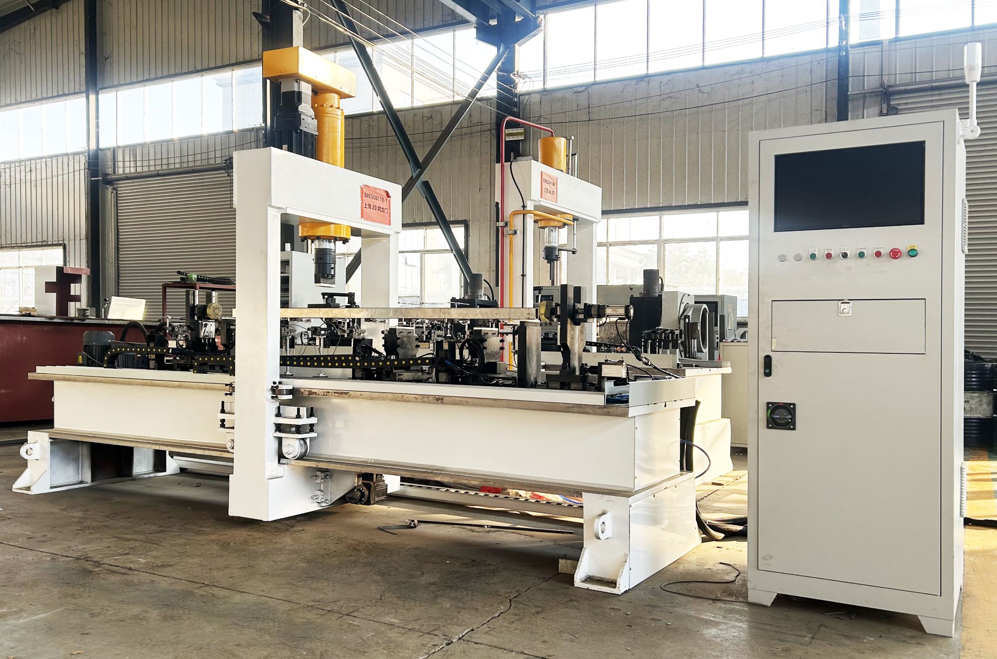 Detailed view of automatic square tube straightening machine work area showing tooling and sensor placement