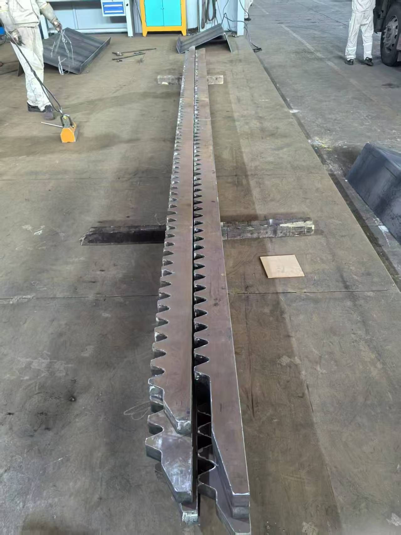 Serrated rectangular steel profile brought in by customer for straightening trial &mdash; non-standard geometry handled successfully